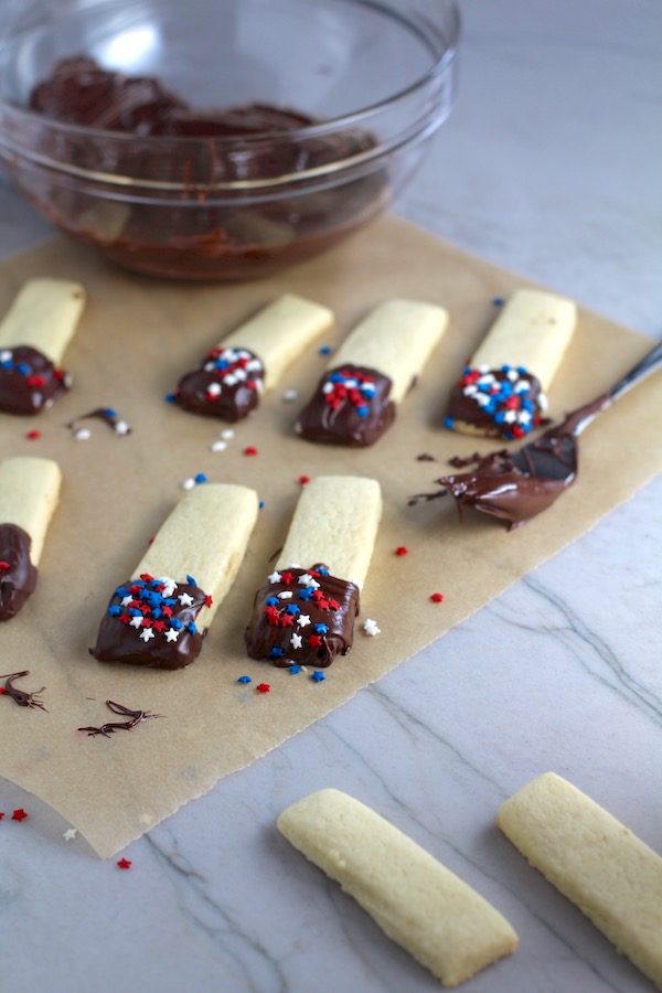 Cut Out Sugar Cookies dipped in chocolate and then topped with red, white, and blue star sprinkles.