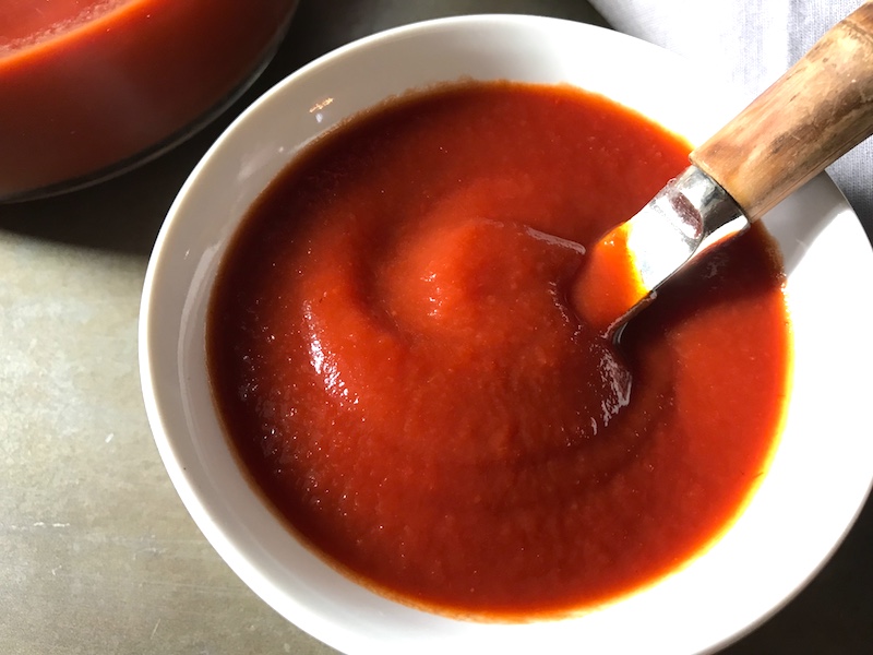 This is EASY Homemade Ketchup will blow your mind and make you feel so accomplished!  It takes only MINUTES to make and has only 5 Ingredients.  Honey is the natural sweetener instead of refined sugar and – I am not kidding you – it tastes amazing!
