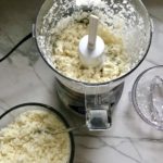 Making cauliflower rice at home is so simple with a food processor! This is great in this Cheesy Cauliflower Rice Recipe!