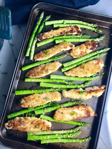 This One-Pan Parmesan Crumb Chicken and Asparagus is crispy, healthy, filling, easy, and delicious. The chicken is simply breaded with a mixture of parmesan cheese and breadcrumbs. The Asparagus is lightly seasoned with extra virgin olive oil, garlic, salt, and pepper. Sprinkle the entire pan with scallions for a mild onion flavor and this dish is loaded with amazing but simple delicious-ness!