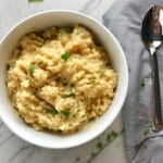 Welcome to my new favorite comfort food with a healthy twist: Cheesy Cauliflower Rice.  If Mac and Cheese met Cauliflower, fell in love and had a baby, it would be this Cheesy Cauliflower Rice. This recipe is so simple with just the flavors from the cauliflower - plus a few other things to help it come together.