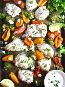 Cilantro Lime Yogurt Chicken, Peppers & Broccoli on a pan with sauce