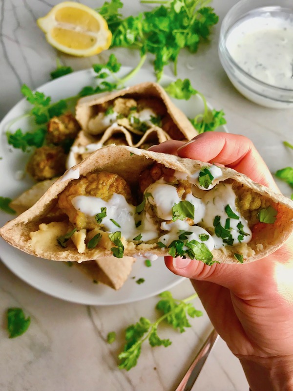 Moroccan Meatball Stuffed Pitas are filled with homemade hummus, moist turkey meatballs made with warm Moroccan spices like ginger, turmeric, and coriander, and then topped with creamy, fresh and bright lemon yogurt sauce.
