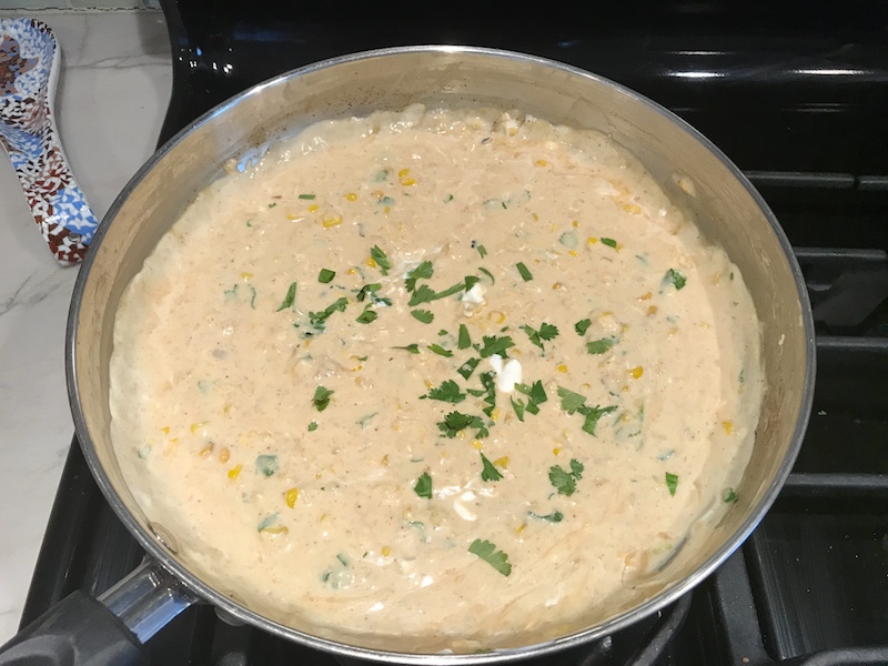 Mexican Corn Cream Sauce in Pan on stove with cilantro on top for Chipotle Meatballs with Mexican Corn Cream Sauce