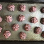 Raw meatballs on a pan for Chipotle Meatballs with Mexican Corn Cream Sauce