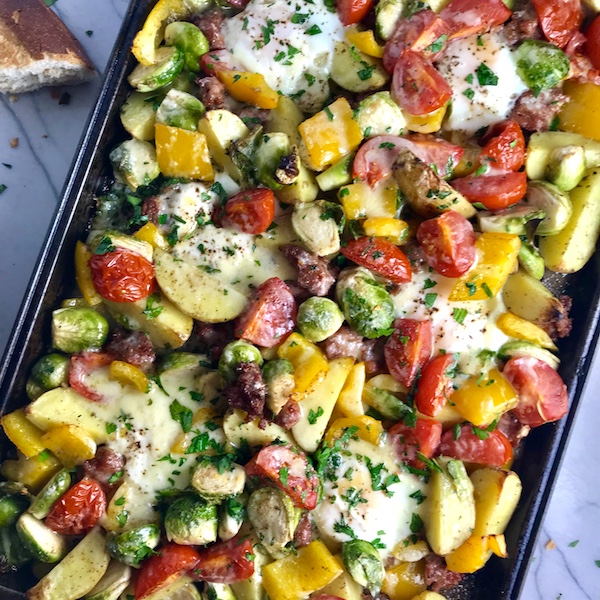 This Sheet Pan Egg, Potato, Sausage Recipe is LOADED with flavors and textures. You get the salty Italian Sausage, sweet bell pepper, creamy potatoes, sweet and juicy tomatoes, meaty brussel sprouts, creamy eggs, and salty, nutty cheddar cheese. Best of all, the entire meal cooks on one large pan!