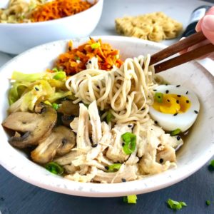 Rockin’ Ramen Noodles with Chicken have flavorful broth, hearty chicken, crunchy veggies, creamy egg, sesame seeds & scallions.  Gluten-Free too!