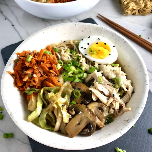 Rockin’ Ramen Noodles with Chicken have flavorful broth, hearty chicken, crunchy veggies, creamy egg, sesame seeds & scallions.  Gluten-Free too!