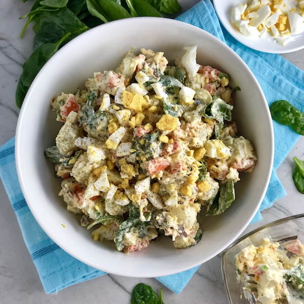 This Fully Loaded Potato Salad has salty bacon and cheddar cheese, creamy and rich egg, fresh scallions and baby spinach, and crunchy carrots.  The dressing is simple with a blend of yellow mustard and mayo.  Make ahead and enjoy later! YUMM-Y!