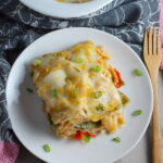 White Enchilada Casserole with Chicken & Veggies is hearty, cheesy, delicious, & easy because everything is layered in one dish. #healthydinner #familydinners #chickendinners #chickenrecipes