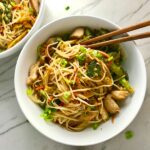 Peanut Teriyaki Chicken & Broccoli with Noodles in a bowl with chopsticks on the counter