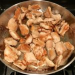 Chicken cooking in pan for Peanut Teriyaki Chicken and Broccoli stir fry with rice noodles.