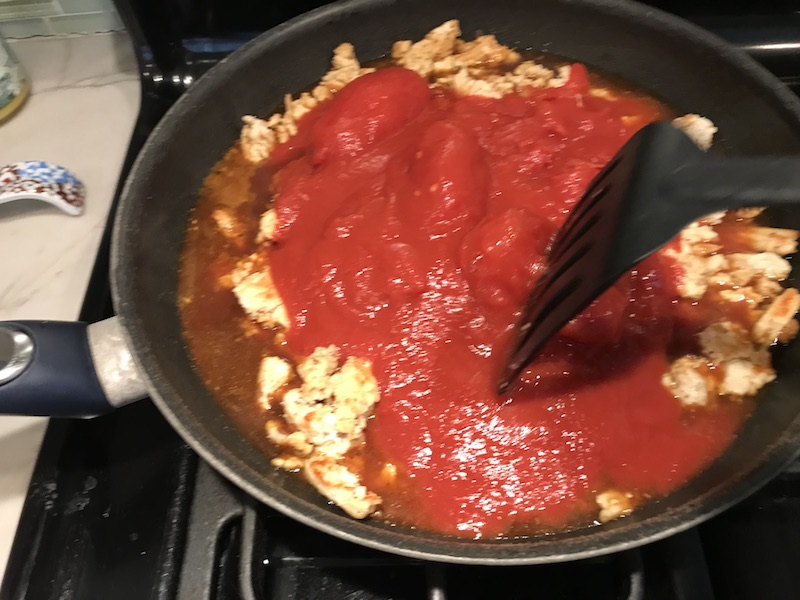 This Skillet Ground Chicken Tomato Sauce with Ricotta is a delicious and simple one pan meal.  Ground chicken is seared until it gets a super browned, flavorful crust.  Then garlic, vegetable broth and tomatoes are added and cooked down into a delightful sauce that really lets the tomato shine with a meaty bite from the chicken.  After pasta is mixed in, creamy Ricotta Cheese is dolloped on and fresh basil added to garnish.  It's perfection! Bellissimo!