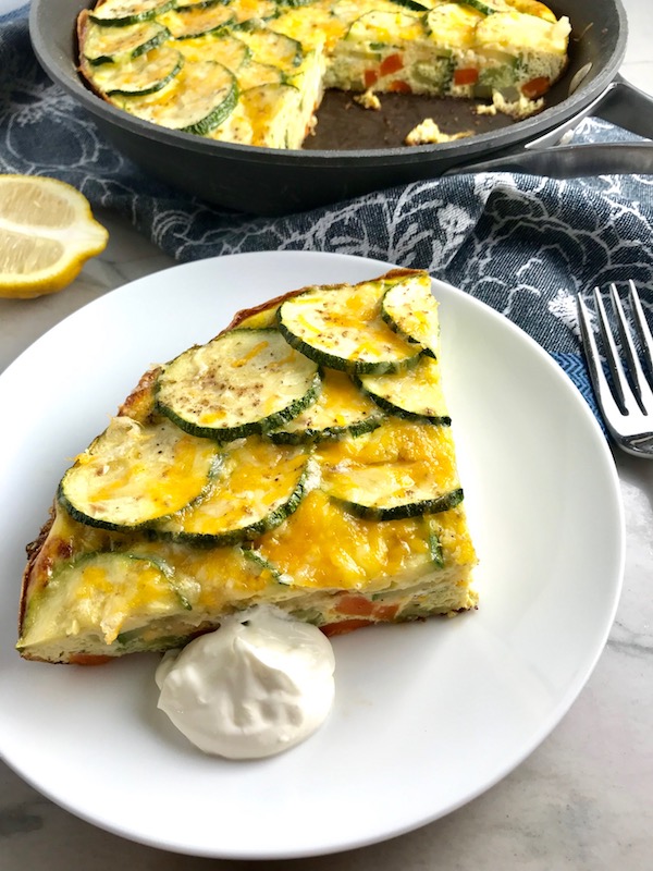 Vegetable Frittata with Lemon Crema is an easy weeknight dinner, quick breakfast, or weekend brunch recipe! This Vegetable Frittata is thick and hearty with lots of flavors and textures from the veggies, but is also light and creamy from the eggs and cheese. It's loaded with healthy veggies, is gluten free, and super EASY to make and to clean up after. 