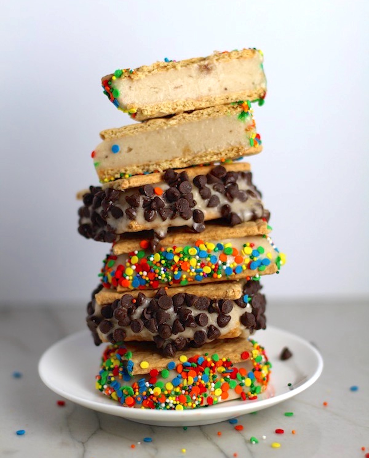 Banana almond milk  Ice Cream Sandwiches with Sprinkles and chocolate chips stacked on top of each other.