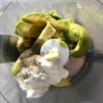 Avocado pieces, sour cream, salt, pepper, and lime juice in food processor for Avocado Crema to go with Roasted Carrot Fries.