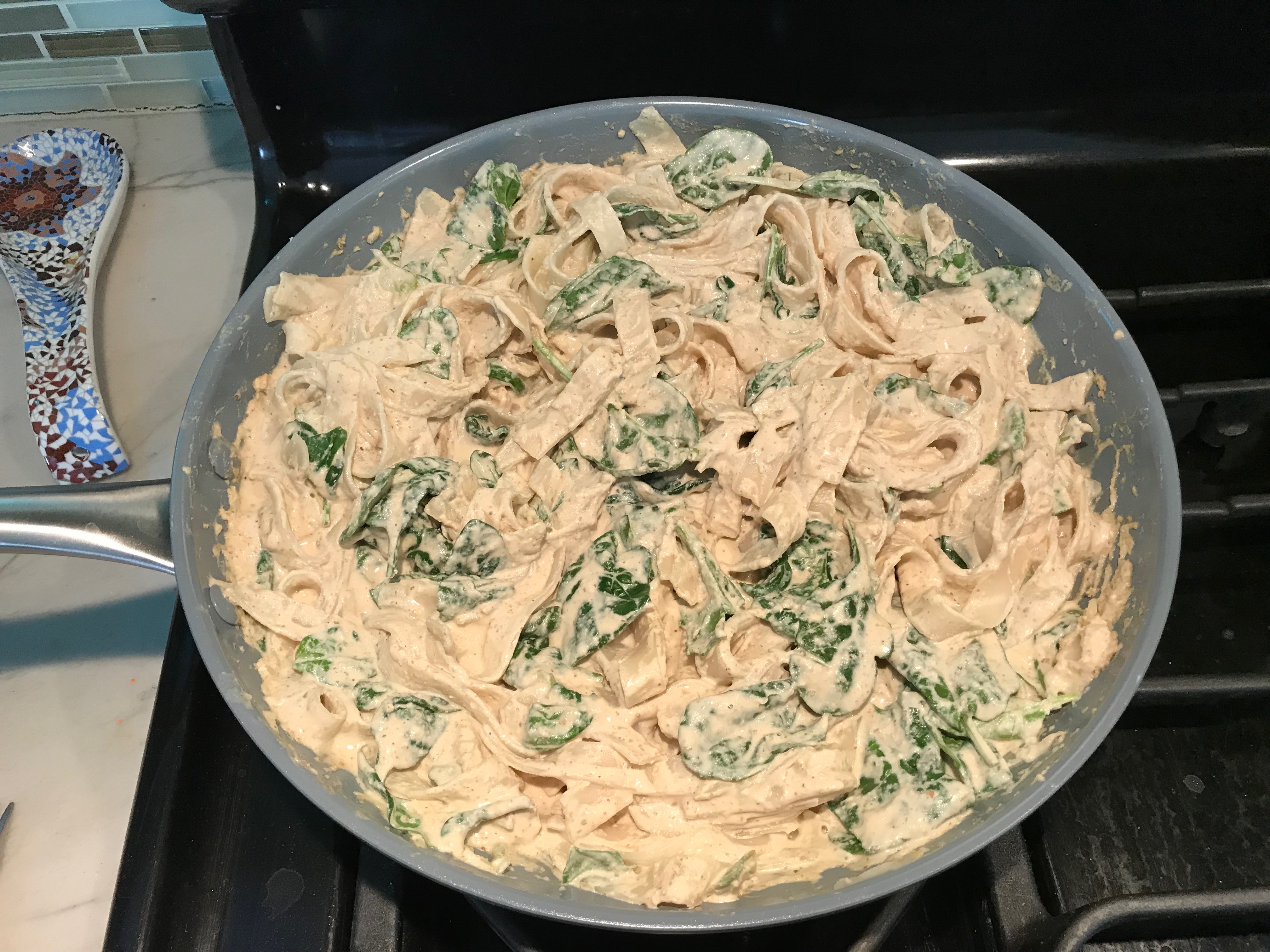 Walnut cream Sauce, Spinach, and Fettuccine all mixed together in a skillet on stove top. This Walnut Sauce recipe with Ricotta and Spinach is thick, rich, nutty, and creamy.  It's inspired by the traditional Italian Walnut Sauce from the North-Western Italy, Liguria Region, but my Walnut Sauce recipe adds even more decadence with creamy ricotta and more nutty parmesan cheese.
