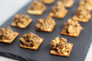 Cooked Hanky Panky on Black Slate Platter. These Hanky Panky Canapes are the BEST Party Appetizers around!Â  They cheesy, meaty, and absolutely delicious.Â  Ground Beef is mixed with Homemade Chicken Sausage and then combined with lots of cheese until its a creamy addictive pot of goodness.Â  Then it is scooped on top of bread, toasts, or crackers