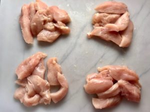 Raw chicken cut and split into 4 portions. This Freezer Hoisin Chicken with Red Peppers, Carrots, Onions, Ginger, and Soy sauce is delicious and so easy to make. You get sweet and savory all in one dish and it's perfect for kids because it's sweet, not spicy at all. Just freeze ahead, thaw, then cook on a sheet pan!