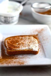 Pumpkin Spice on yogurt on toast with yogurt tub in background. Recipe has 4 simple ingredients and takes minutes to make! PLUS, here are 20 EASY WAYS TO USE this Spice blend, many with no baking at all!