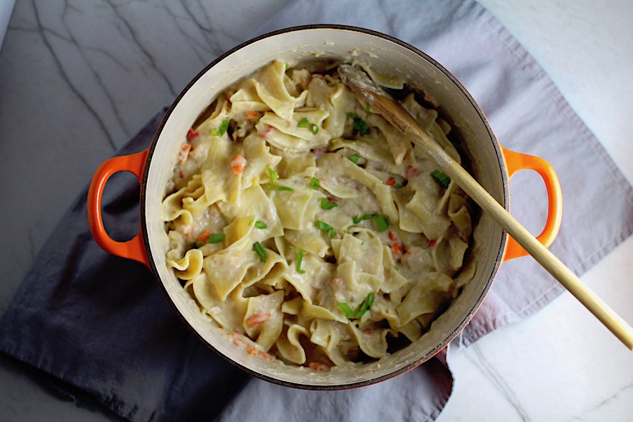 Cheesy Tuna Noodle Casserole Recipe in a pot on counter. This is a creamy and delicious comfort dish with tuna and noodles and a surprise pop of sweet from Pimiento.  This easy recipe is completely from scratch (no canned soup here!) but I can promise you it's so easy and only takes 30 minutes because it's a Casserole that you can make entirely on the stove top!