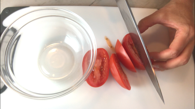 Slicing Plum Tomato for Bruschetta topping. It combines fresh tomatoes, artichoke hearts, garlic, basil, olive oil, and GOAT CHEESE!Ā Top on toasty garlic crostini and you get fresh bright flavors with both crunch and creamy in every bite.