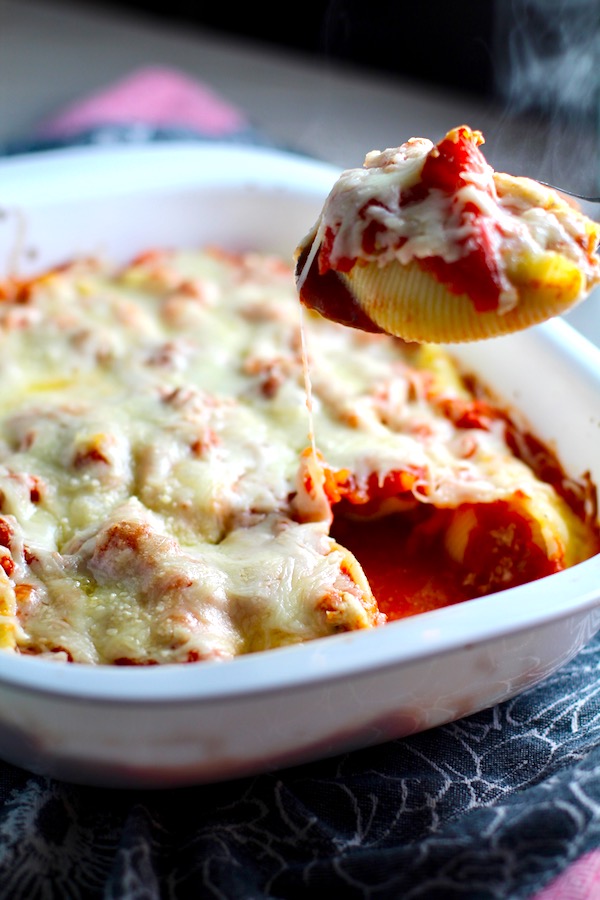 Turkey Ricotta Stuffed Shells in Tomato Sauce in casserole dish with piece scooped out. These are the perfect way to repurpose and transform leftover Turkey or Chicken. The Shredded Turkey, Italian seasonings, mozzarella, and ricotta are stuffed in shells and topped with a simple tomato sauce and more melty mozzarella and nutty parmesan, it's a perfect dish that the family will love!