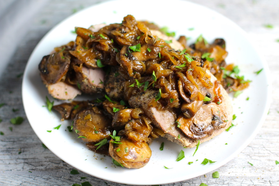 Caramelized Onions & Mushrooms on Sliced Pork Tenderloin on plate.  This recipe is such a flavorful main dish!  The pork tenderloin is moist and juicy and topped with Onions & Mushrooms that are sauteed low and slow with a touch of balsamic to bring out all of the natural sugars and caramelize them to perfection.