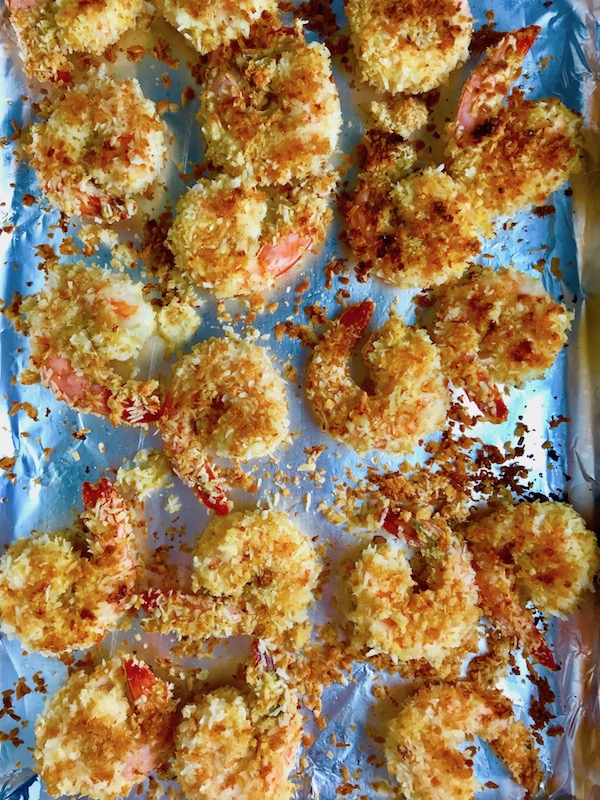 Baked Coconut Shrimp on pan. Crunchy and utterly irresistible, this 30-Minute Baked Coconut Shrimp recipe is one that you have got to try!  They are baked, not fried, so they are EASY to cook and HEALTHIER for you too! 