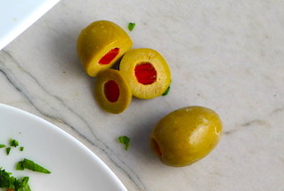 Sliced Olives for the Creamy Olive Chicken recipe. This is magnificently thick and creamy and infused with garlic flavor and nuttiness from the Parmesan. The best part; however, is the salty and briny flavor kick from the green olives with a little sweetness from the pimiento. #chicken #chickenrecipes #chickendinner #easydinners #easyrecipes #comfortfood #casserole