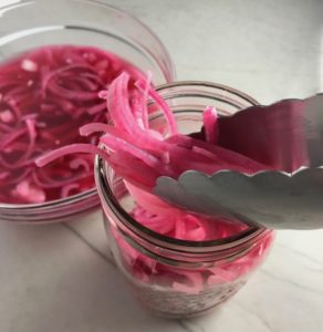 Pickled Onions for Slow Cooker Pork Tacos with with Pickled Onions, Shredded Cheese, and Cilantro Lime Crema drizzled on top!  It's such an easy dinner since the pork cooks in the slow cooker to be perfectly seasoned and fall apart tender. #tacos #easydinner #glutenfree #dinner #mexican #pork