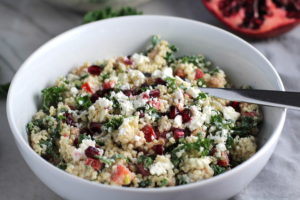 Close up of bowl of Quinoa & Kale Salad with Roasted Chickpeas, Pomegranate, Feta, red pepper, and Creamy Lemon Dressing. #glutenfree #lunch #dinner #healthyrecipes #healthyfood #salads #quinoa #kale