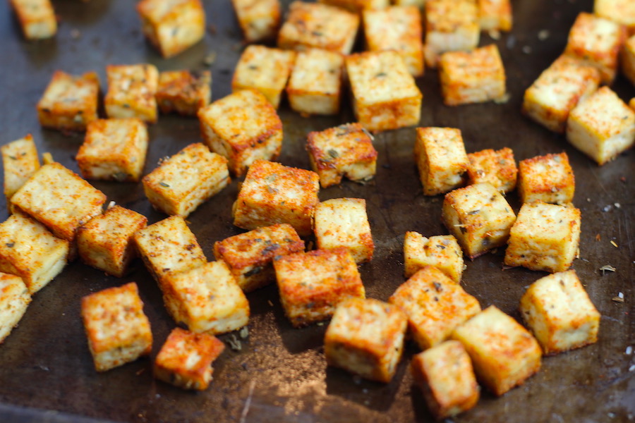 Roasted Tofu Croutons on pan. These are seasoned and toasted for the perfect addition to any salad, pasta, rice, or soup!   They get a roasted, almost nutty flavor with a salty and smoky seasoned crust with a chewy bite.  Super easy to make, low carb and great source of protein!  #croutons #salad #tofu #tofurecipes #vegetarian #plantbased #paleo