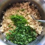 Chopped cilantro and lime zest on quinoa in pot for Cilantro Lime Quinoa. It's fluffy, nutty, citrusy, salty, and the perfect accompaniment for any protein or vegetable!  With just a few simple ingredients, you can make this fantastic healthier alternative to rice. #quinoa #quinoarecipes #sides #healthyfood
