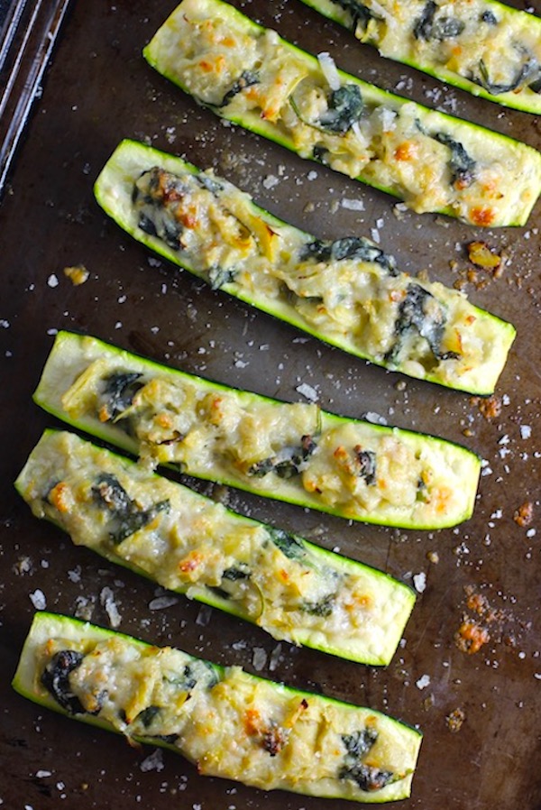 Spinach Artichoke Stuffed Zucchini on a pan.  Each fantastic bite gives you creamy artichoke, nutty cheesy Parmesan,  spinach, and zucchini.  Prepare entirely ahead, then bake 20 minutes and enjoy!  #vegetarian #zucchini #stuffedzuchini #spinach #artichoke #springrecipes #healthyfood #healthydinner #healthyrecipes #glutenfree