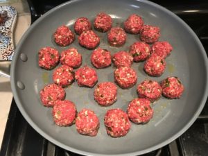 Raw meatballs in skillet for Meatballs in Cauliflower Dill Cream Sauce. #meatballs #swedishmeatballs #familydinner #easydinner #dinner #healthydinner