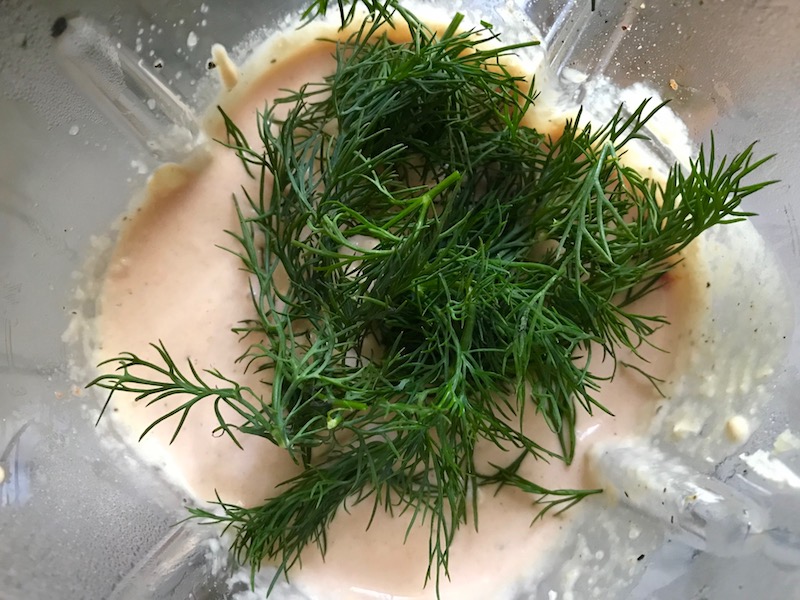 Fresh Dill added to Cauliflower cream sauce over blender for Meatballs in Cauliflower Dill Cream Sauce. #meatballs #swedishmeatballs #familydinner #easydinner #dinner #healthydinner