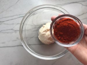 Adding paprika to mayonnaise for the Aioli for Hungarian Paprika Chicken. The paprika gives beautiful color and a deep, peppery flavor. #chicken #easychicken #easydinner #dinner #healthydinner