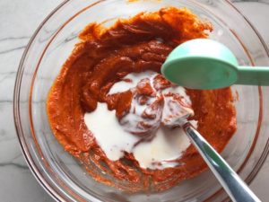 Adding milk to the Paprika Aioli for Hungarian Paprika Chicken. The paprika gives beautiful color and a deep, peppery flavor. #chicken #easychicken #easydinner #dinner #healthydinner