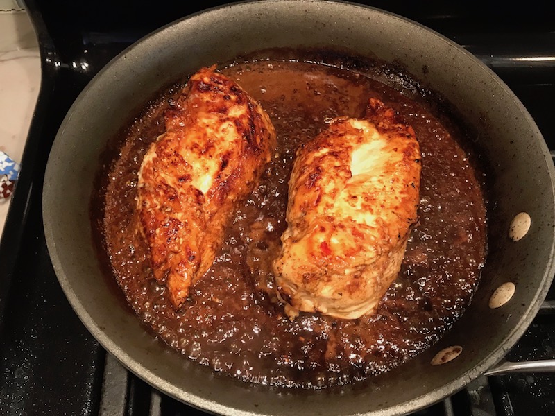 Cooked Chicken in sauce in skillet for Sesame Sweet Chili Chicken recipe. It is slightly sweet, tangy, savory, nutty, with a touch of heat. You can prepare it days ahead, it takes just minutes to prepare, minutes to cook, and everyone will love it!! #chicken #marinades #easydinner #easychicken #chickenrecipes #easysauces #healthydinner #healthyfood #healthyrecipes
