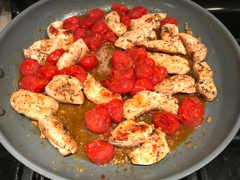 Chicken and Cherry tomatoes cooking in skillet for Chicken and Cherry Tomato Pasta with basil and parmesan. It's easy and so delicious! #pasta #tomatoes #easydinner #dinner #easyrecipes #healthydinner #chicken