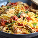 Chicken and Cherry Tomato Pasta with basil and parmesan in a skillet. It's easy and so delicious! #pasta #tomatoes #easydinner #dinner #easyrecipes #healthydinner #chicken