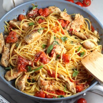 Chicken & Cherry Tomato Pasta in a skillet on counter. One of 10 Must-Try EASY Summer Dinners!
