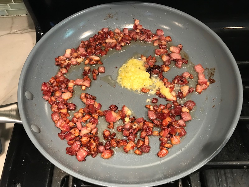 Diced Pancetta cooked in skillet for Pancetta, Parmesan, and Pepper Pasta. The Pancetta gives a salty and slightly peppery flavor, Parmesan cheese creates a nutty and creamy sauce, and the ground black pepper gives a peppery flavor that makes this pasta stand out. #pasta #easypasta #easydinner #dinner #italian #familydinner #onpotdinners #onepandinners #parmesan