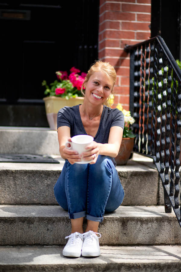 Carrie Tyler, food blogger behind www.talkingmeals.com, sitting on front stoop with coffee.