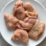 Raw chicken pieces for Skillet Artichoke Chicken with sun dried tomatoes, basil, garlic, in cream sauce. #skilletchicken #skilletdinner #chicken #easydinner #familydinner #italian #tuscanchicken