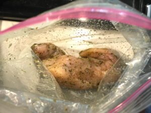 Mediterranean Chicken marinating in a storage bag. This Mediterranean Marinade is only a few ingredients, can be made ahead, and is delicious!