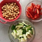 Chickpeas, sliced red pepper, and sliced zucchini for Chickpea Coconut Curry. The sauce has onion, coconut milk, ginger, garlic, and warm Indian Curry spices.