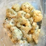 Cauliflower florets mixed with coconut breadcrumbs for Baked Coconut Cauliflower Bites. They have a slightly sweet and salty crunch outside from the shredded coconut and panko mixture.  The inside is soft and creamy.  Dip in the Sriracha Mayo.  Baked, not fried, so healthy!  Easy to make, easy to eat! #cauliflowerrecipes #healthyrecipes #sidedishes #appetizers #healthysnacks