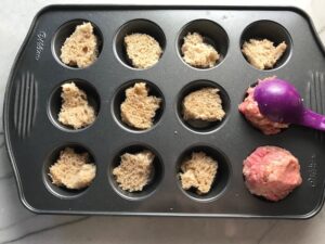 Adding raw meat mixture to bread in bottom of muffin tin slots for Mini Meatloaf Muffins. They have only 5 simple ingredients, cook in 30 minutes, and are gluten free.